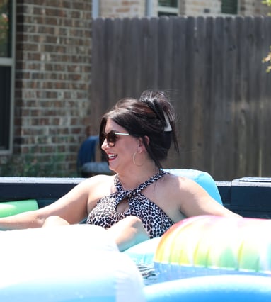 Mom relaxing in her above ground pool.