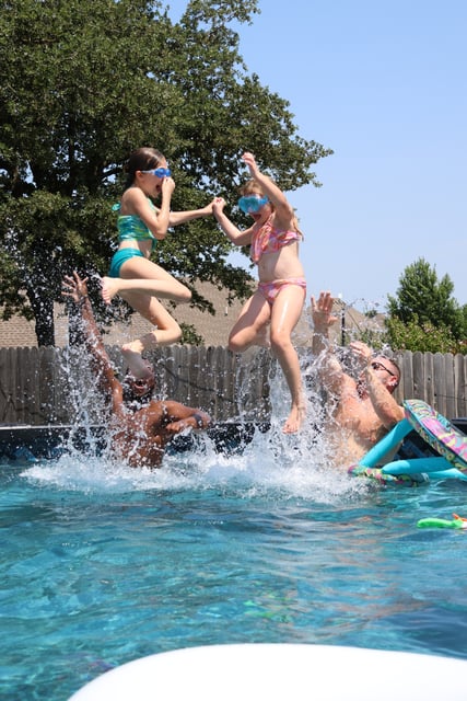 Kids jumping and having fun in the pool