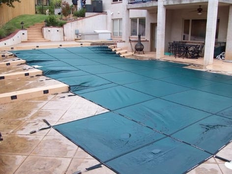 A Country Leisure in-ground pool with protective cover.