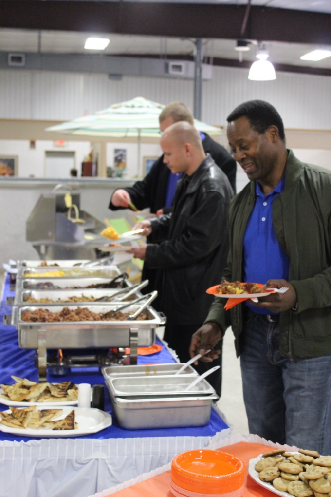 man putting food on his plate