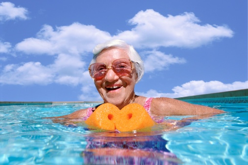 elderly woman with a floaty in the pool