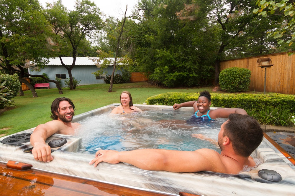 adults enjoying hot tub