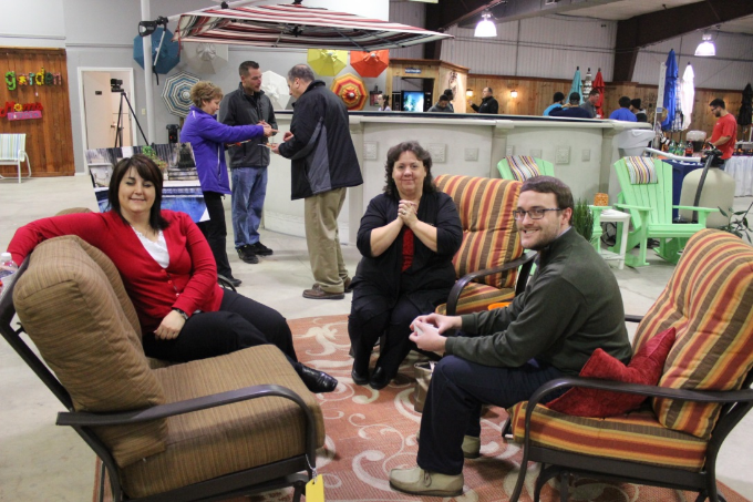 group of people socializing while sitting in chairs