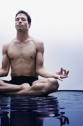 man meditating in the water